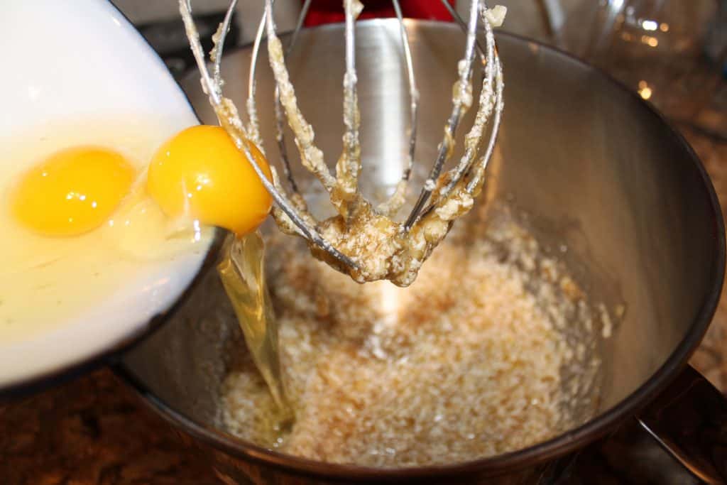 adding eggs to the mixing bowl