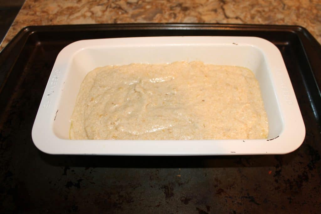 banana bread batter poured into a bread loaf pan