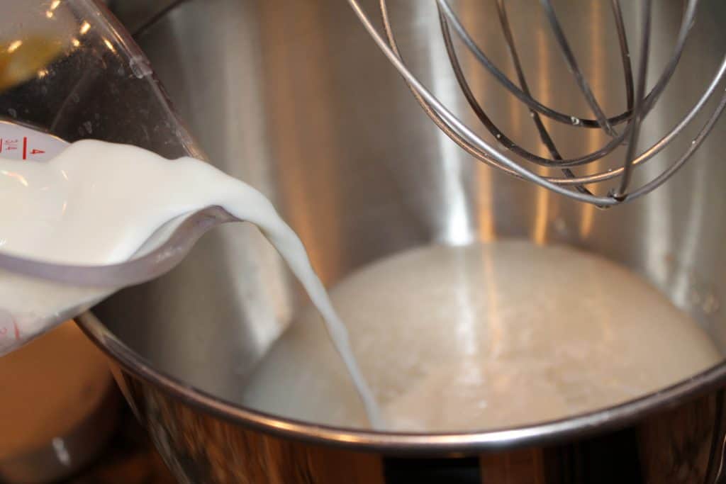 Adding milk to the yeast mixture.