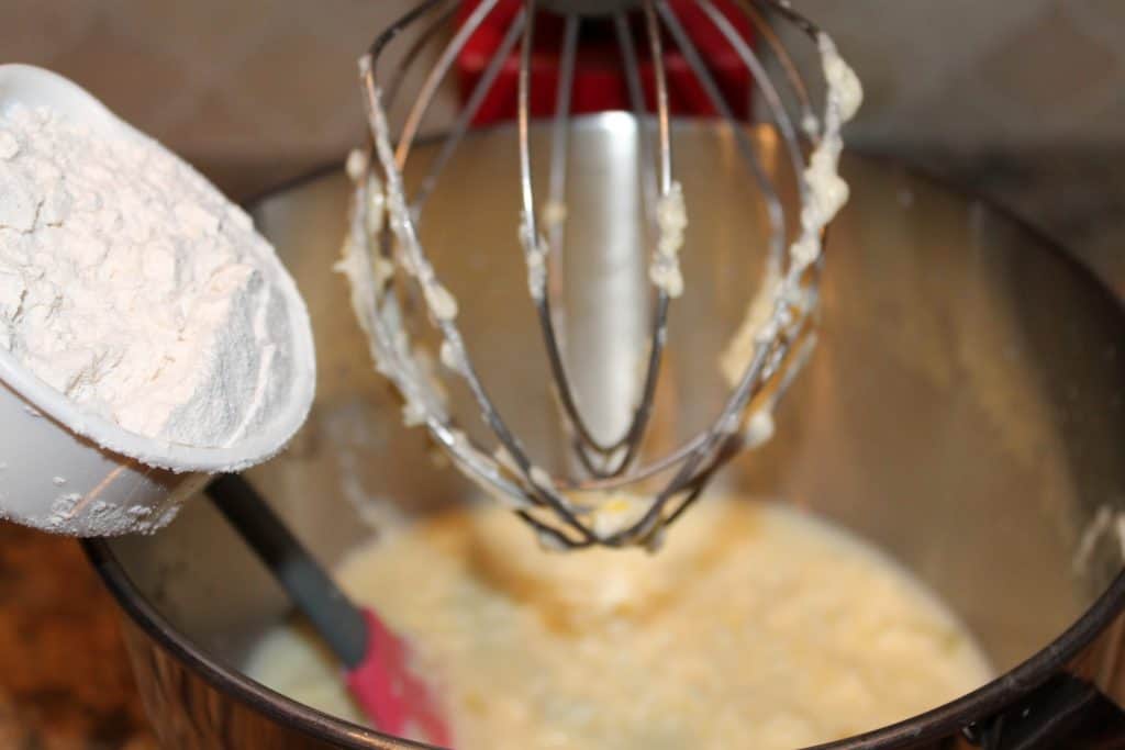 Adding flour to the bowl.