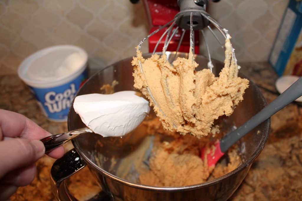 adding cool whip or whipped cream to the mixing bowl