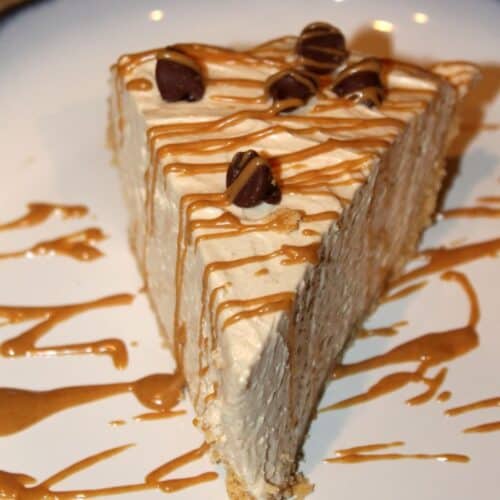 a slice of no bake peanut butter pie with drizzled melted peanut butter on top