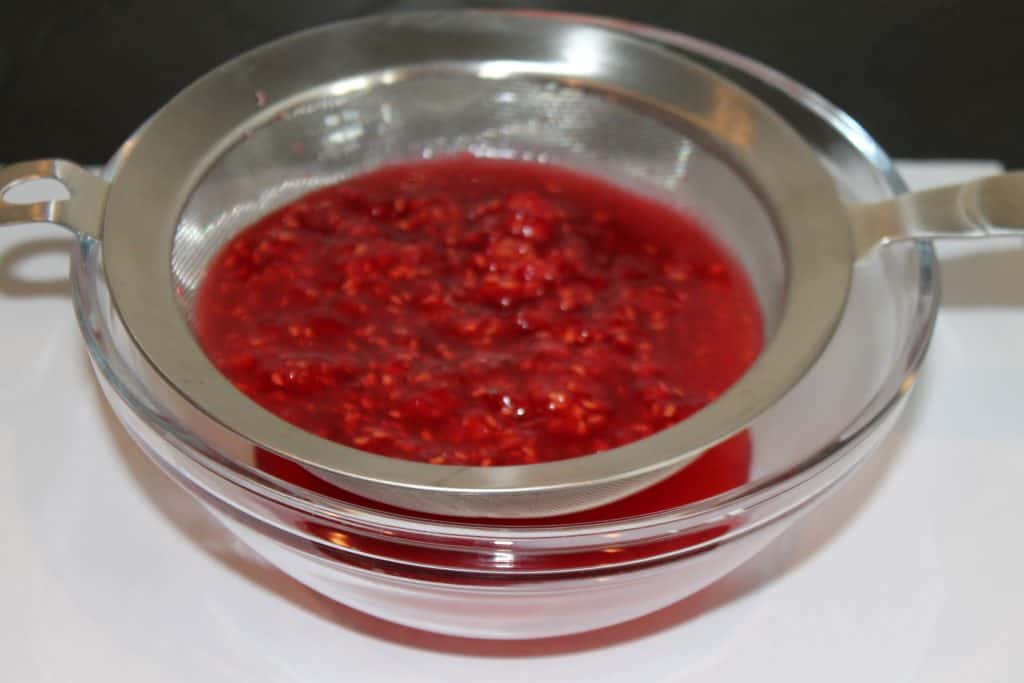 Strain the raspberry puree to remove the seeds.