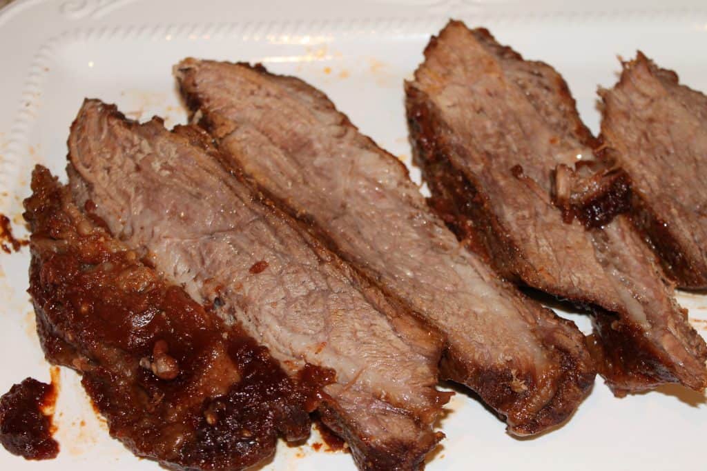 Barbecue brisket sliced up on a white tray