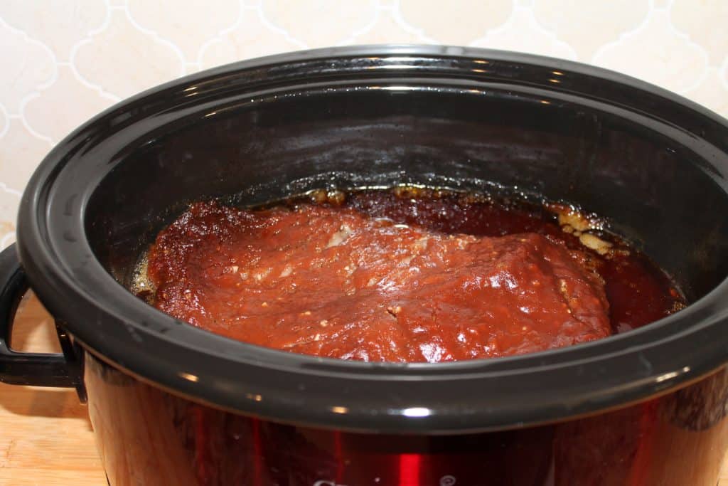 Cooked barbecue brisket in a crock pot.