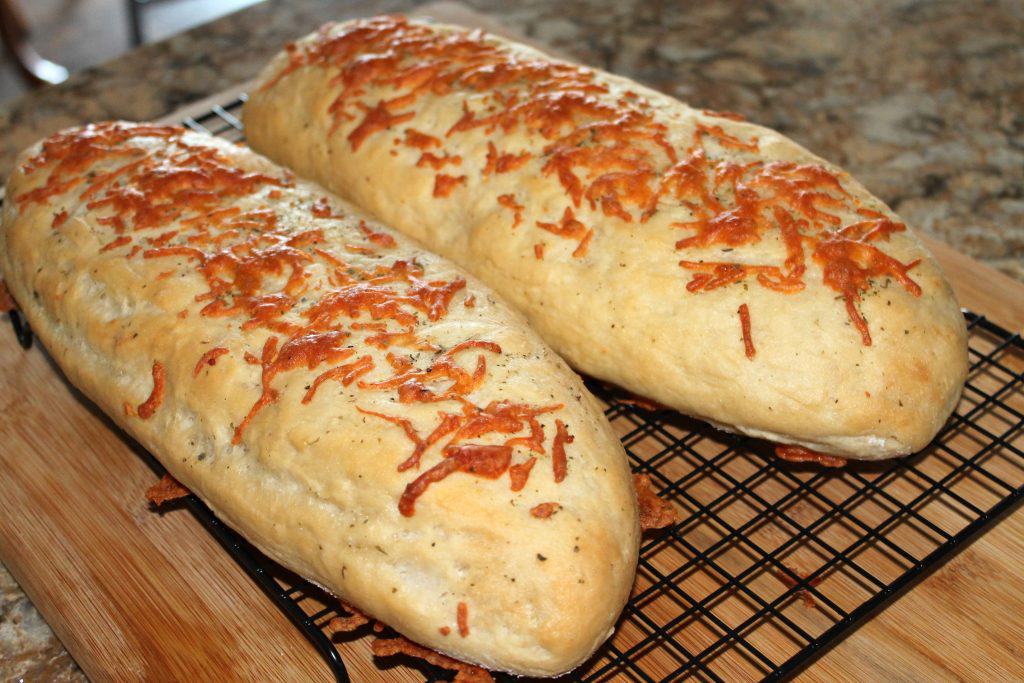 Italian Herbs and Cheese Bread cooling on a rack