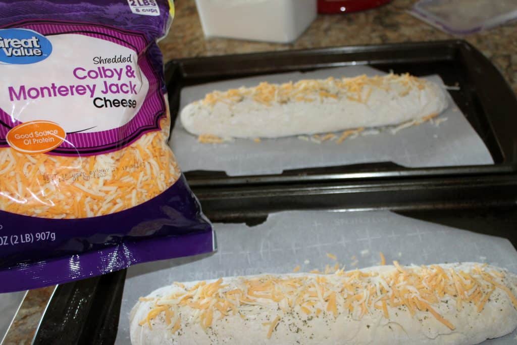 Sprinkling cheese onto the italia herb bread.