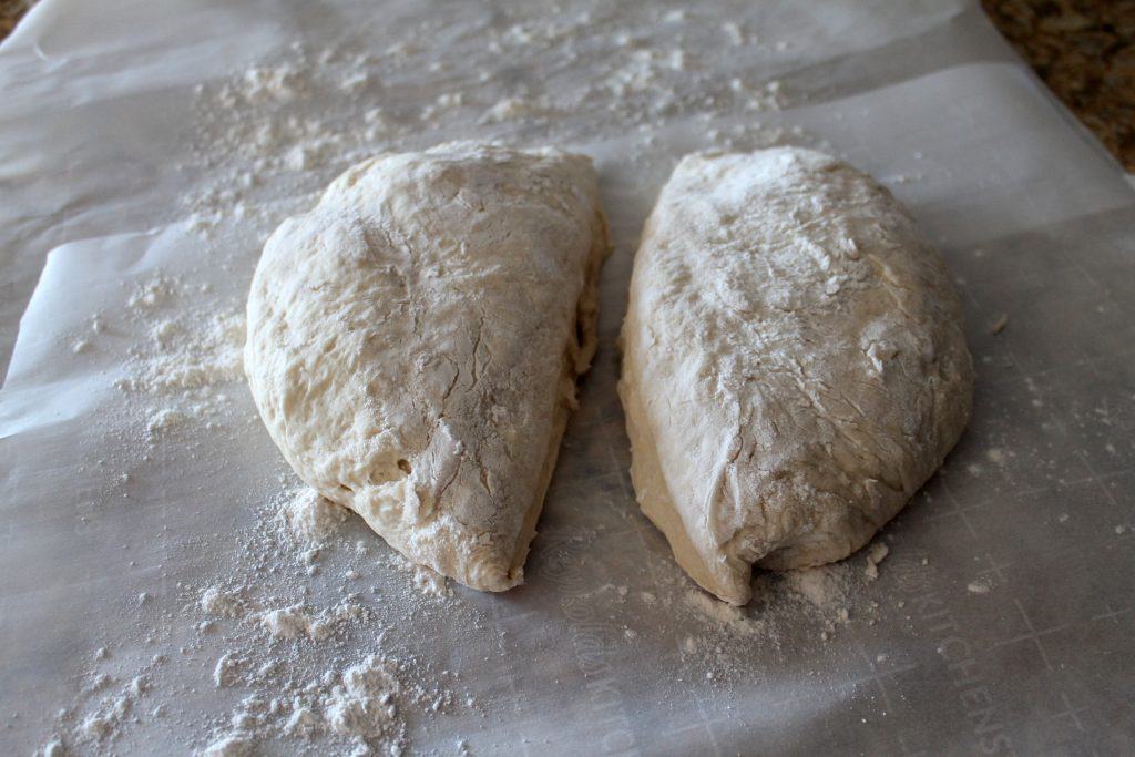 Cutting the bread dough in half.