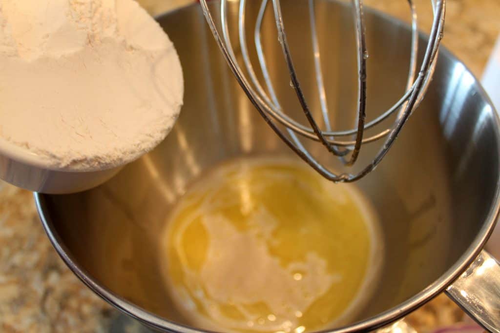 Adding flour to the mixing bowl