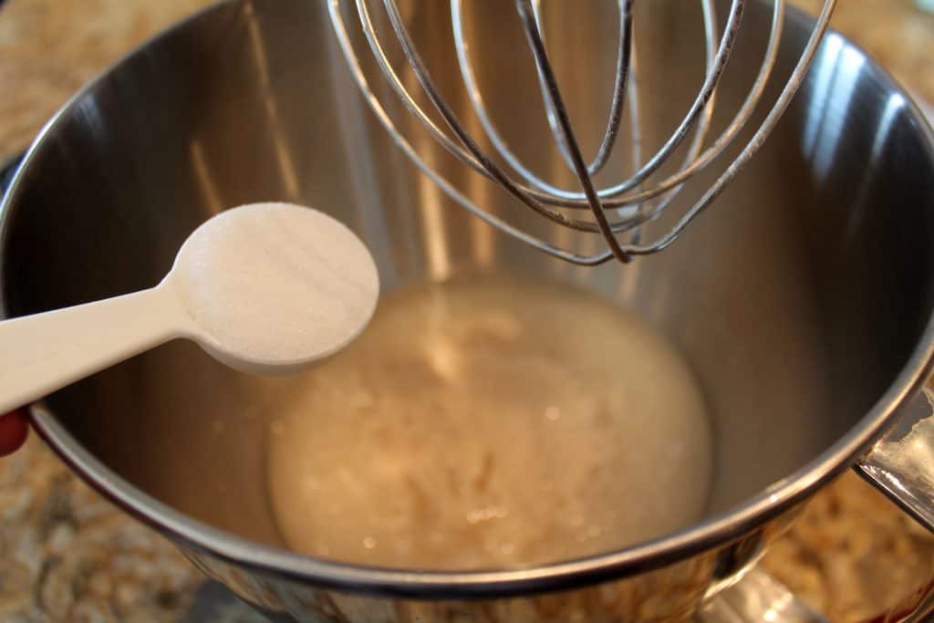 Adding the sugar to the yeast mixture.