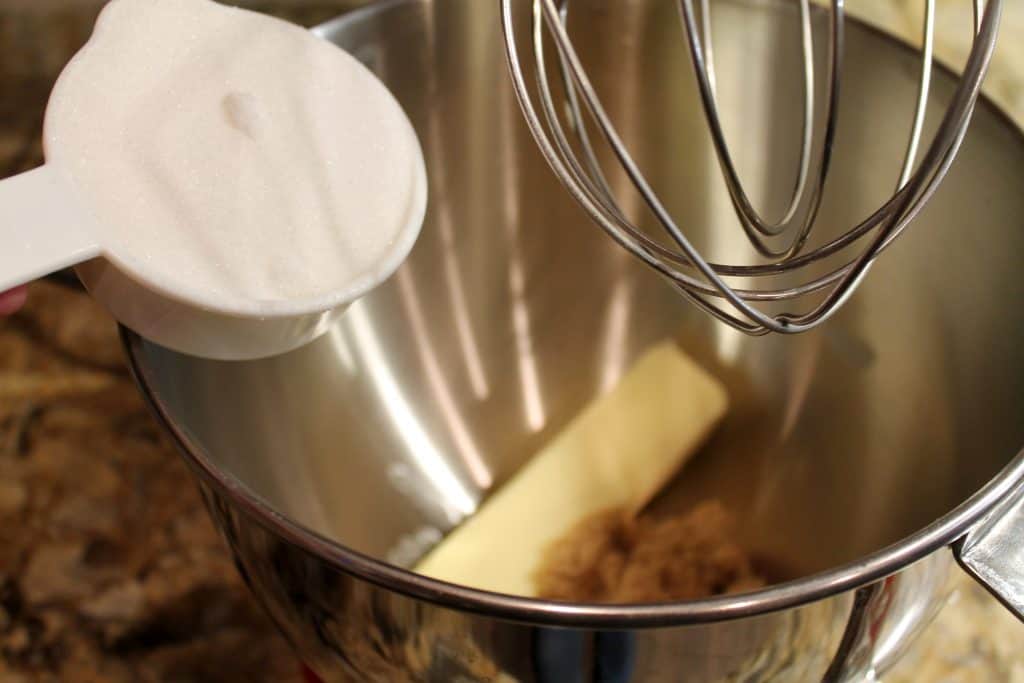 Adding sugar and butter to mixing bowl.