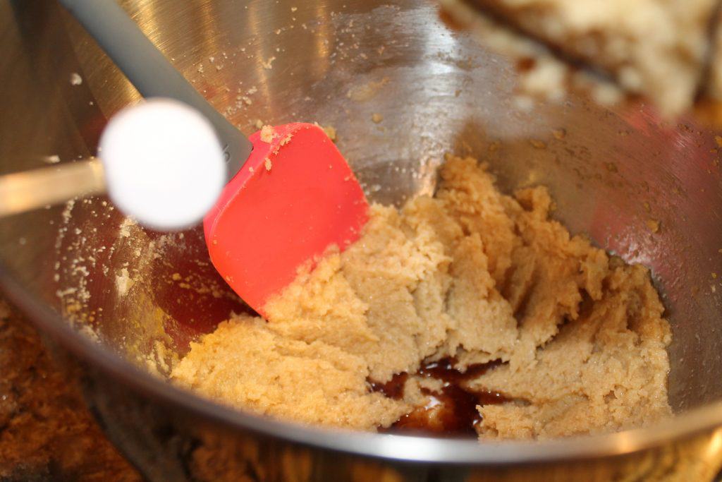 Adding baking soda to the cookie dough.