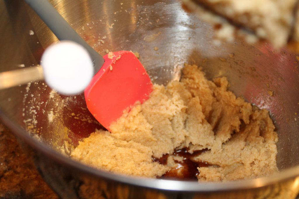 Adding baking soda to the cookie dough.
