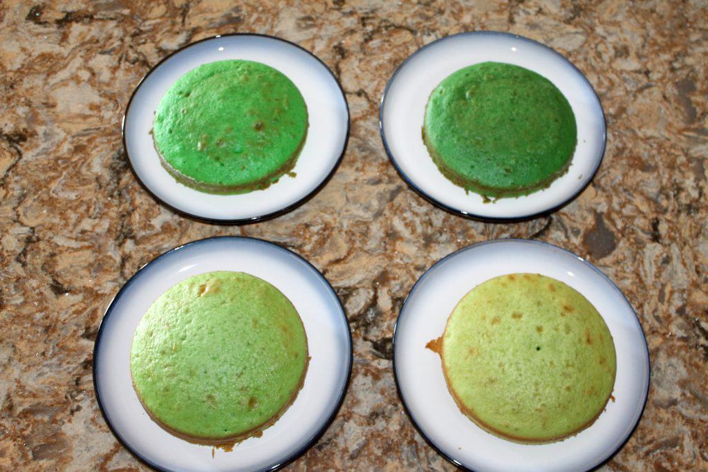 4 different shades of green cakes that are cooked.