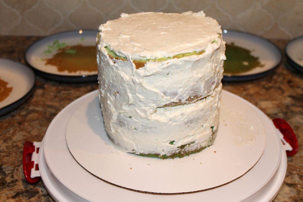 Crumb coat of icing on the 4 layer cake.