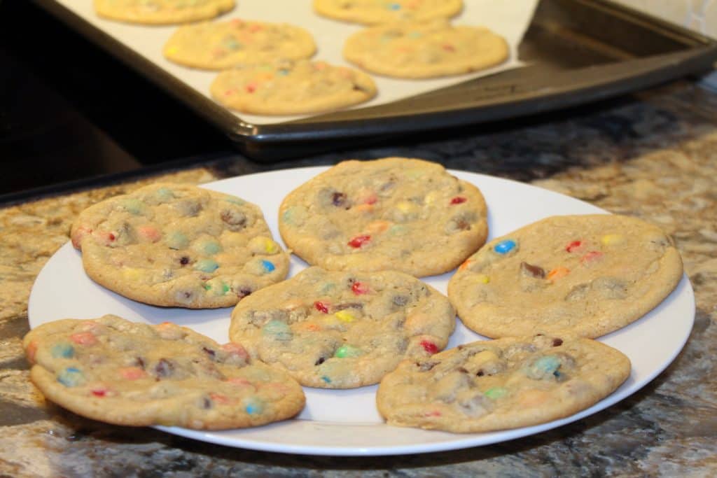 a plate of freshly baked chocolate chip and m&m cookies