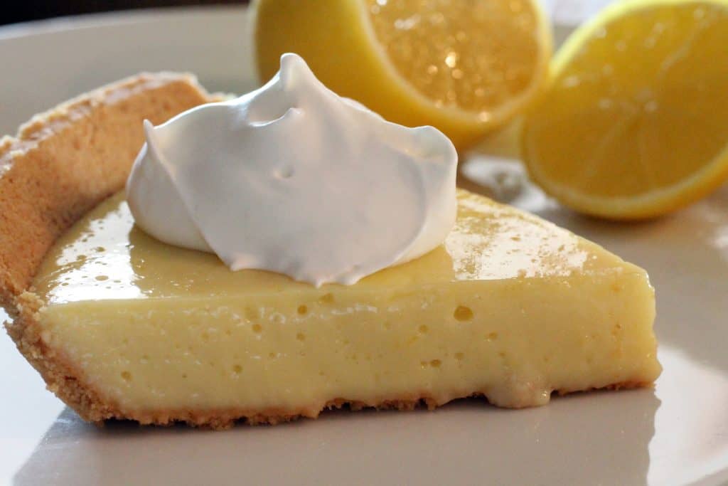 Slice of lemon pie with whipped cream.