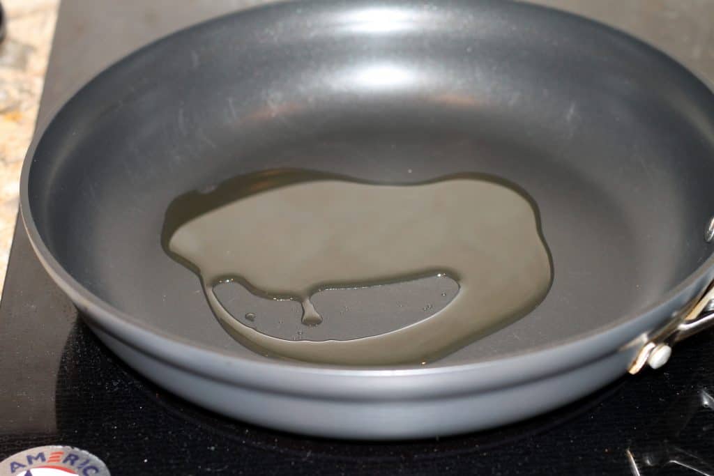 Olive oil added to large frying pan