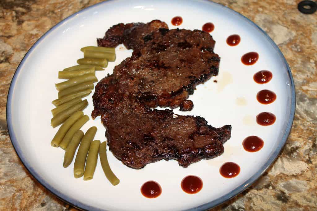 A styled plate of pan seared steak and green beans