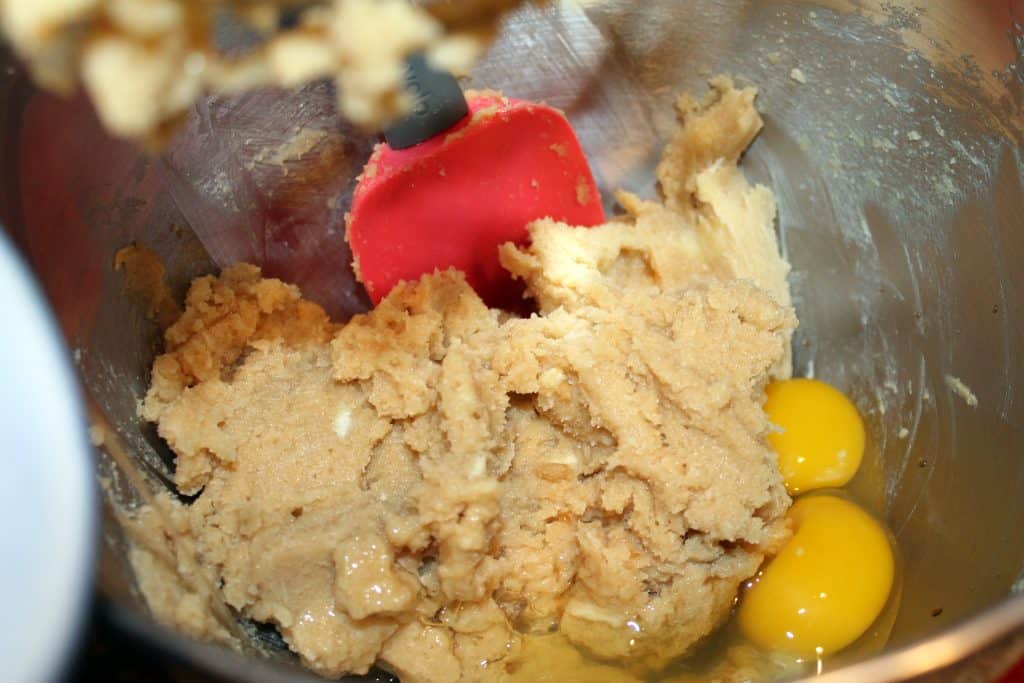 Adding eggs to the butter mixture.