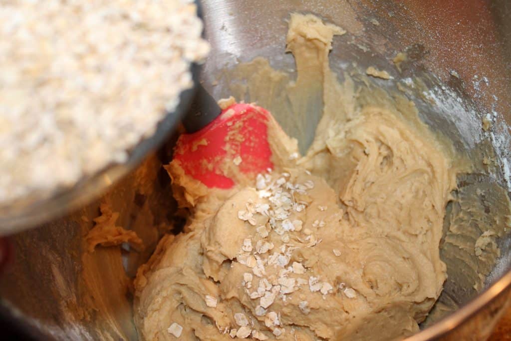 Adding old fashioned oatmeal to the cookie dough