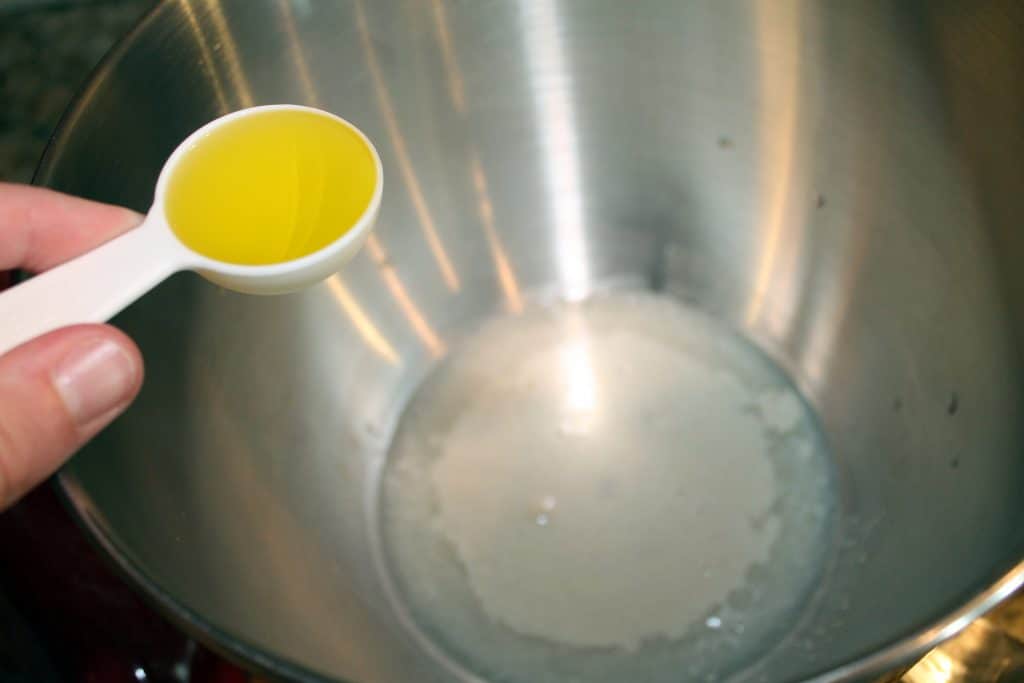 Adding olive oil to the yeast mixture