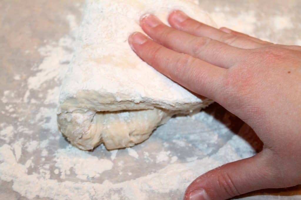 Kneading the pizza dough on a floured surface