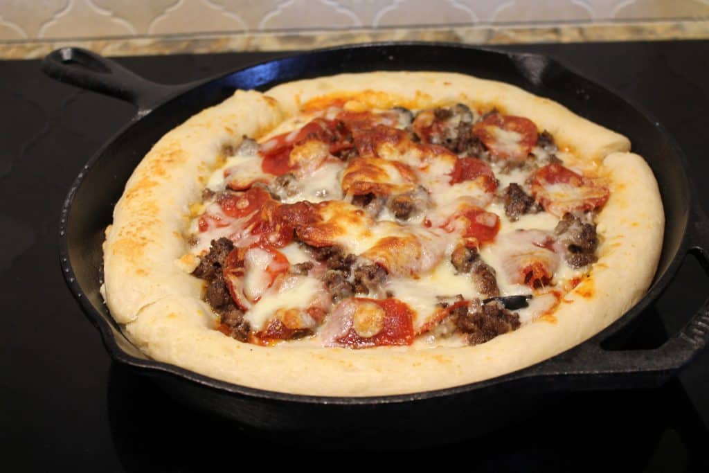 Fully cooked pizza in cast iron skillet