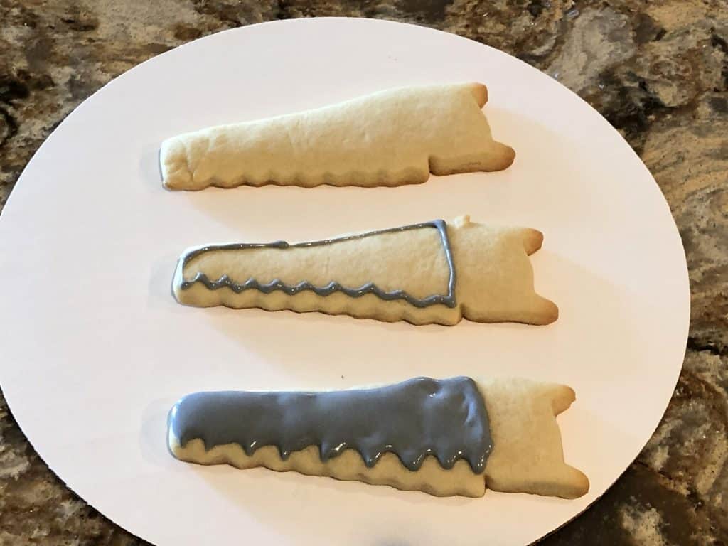 The first steps to decorating a saw shaped cookie.