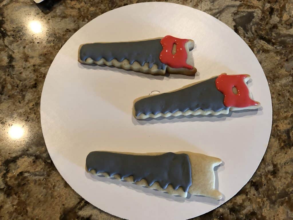 Decorating the red handle of the saw cookie