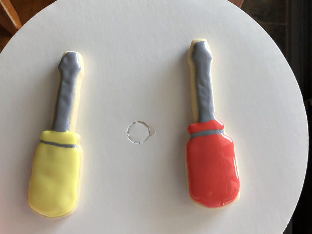 Finished screw driver cookies that are decorated with royal icing