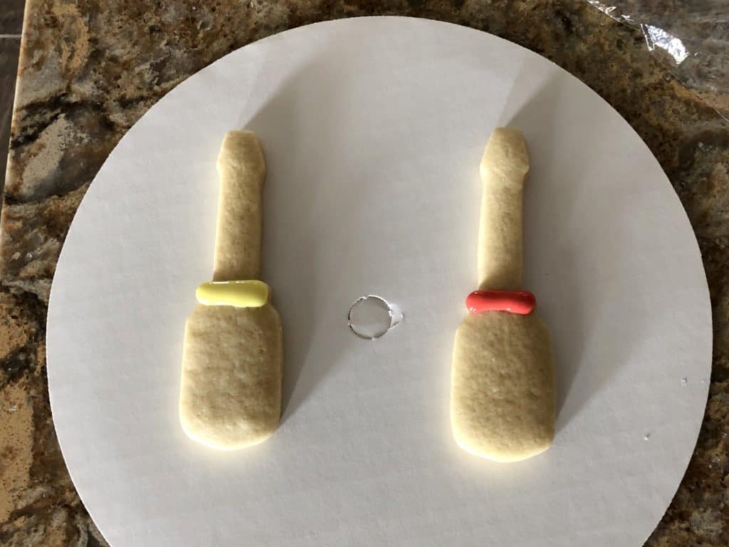 First step to decorating the screwdriver cookie is to decorate the center ring.