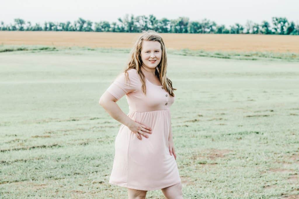 Woman wearing pink dress with button front