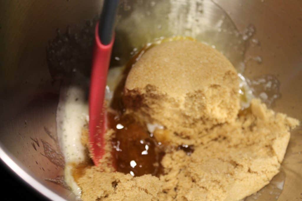 adding brown sugar to mixing bowl with browned butter