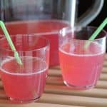 Sparkling pink lemonade in glasses with straws