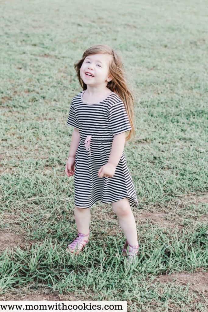 Toddler wearing striped dress from PinkBlush