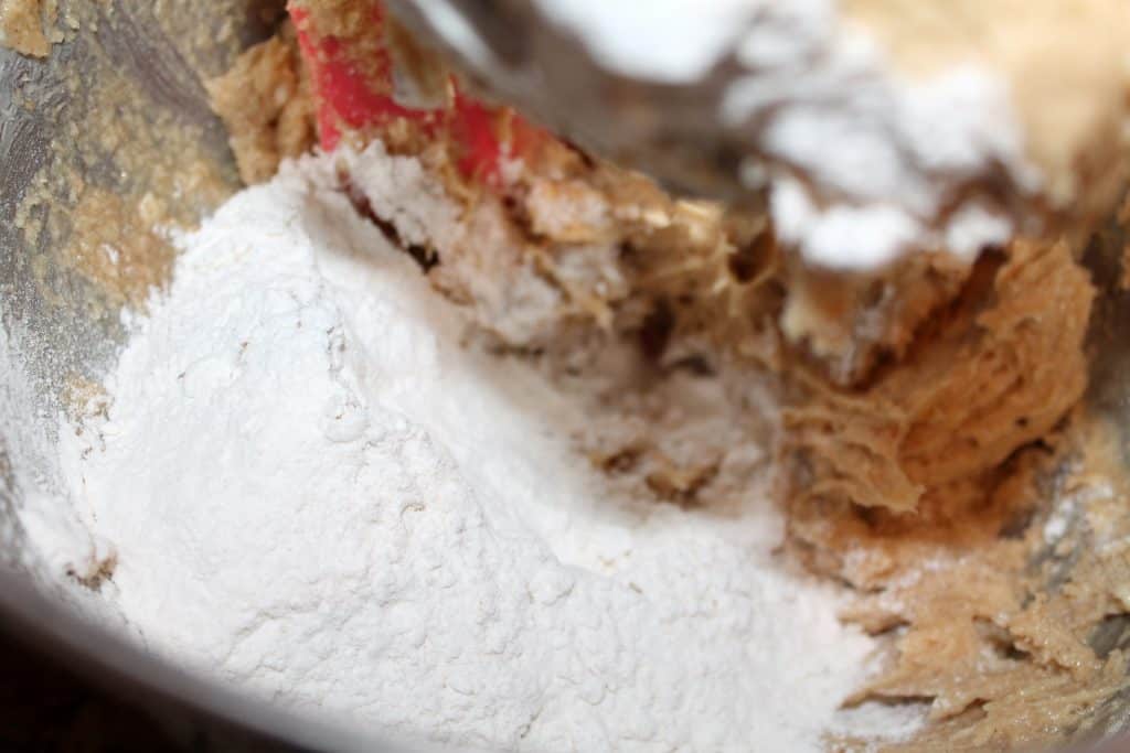 adding the all-purpose flour to the cookie mixture