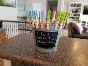 bucket chore chart with clothespins for different chores