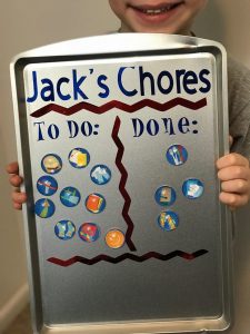 a DIY chore chart made with a cookie sheet and a cricut