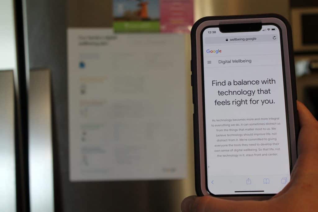 Google's Digital Wellbeing family guide poster hanging up on a refrigerator