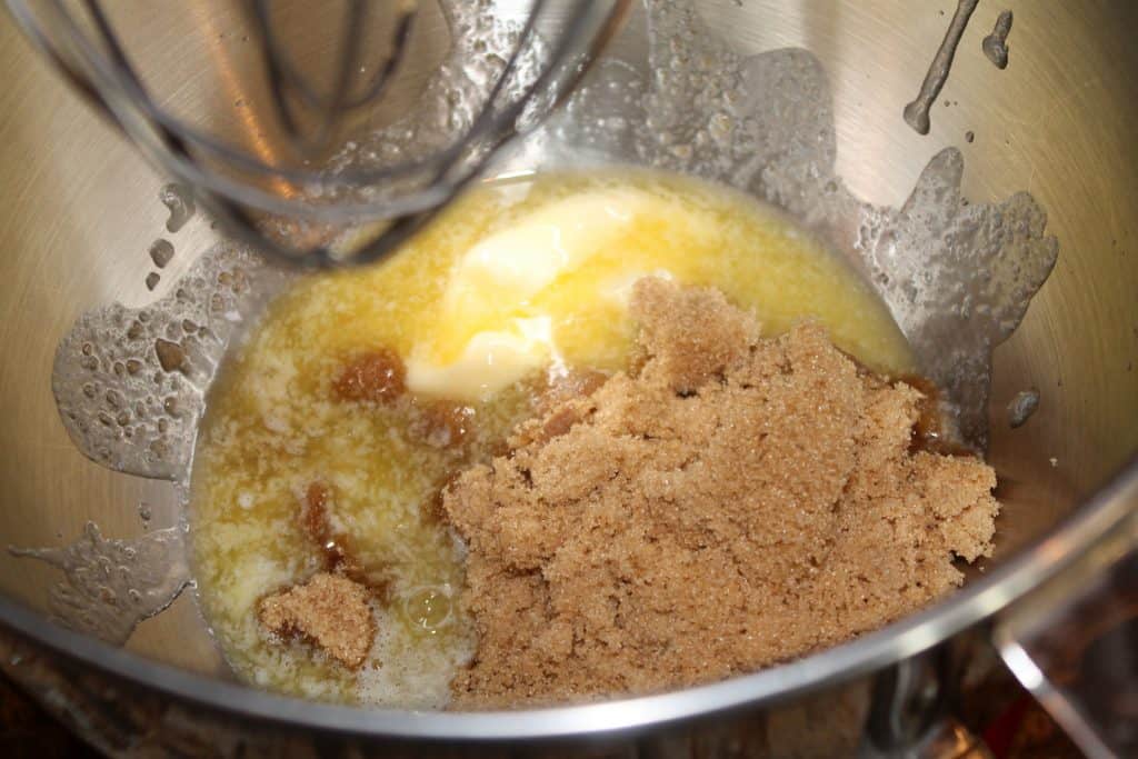 A large mixing bowl with melted butter and brown sugar
