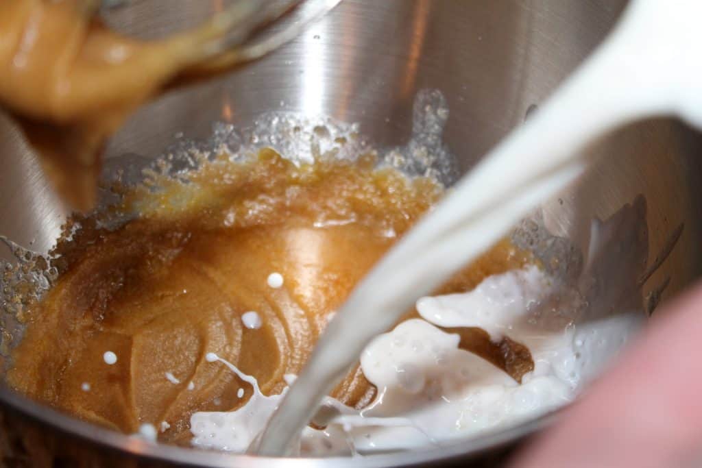 pouring milk into the mixing bowl