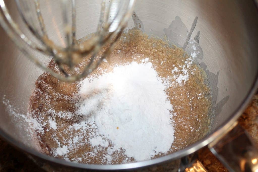 adding flour to the mixing bowl