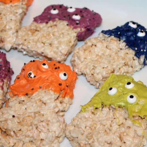 a bunch of fun rice krispie treat monsters on a white platter