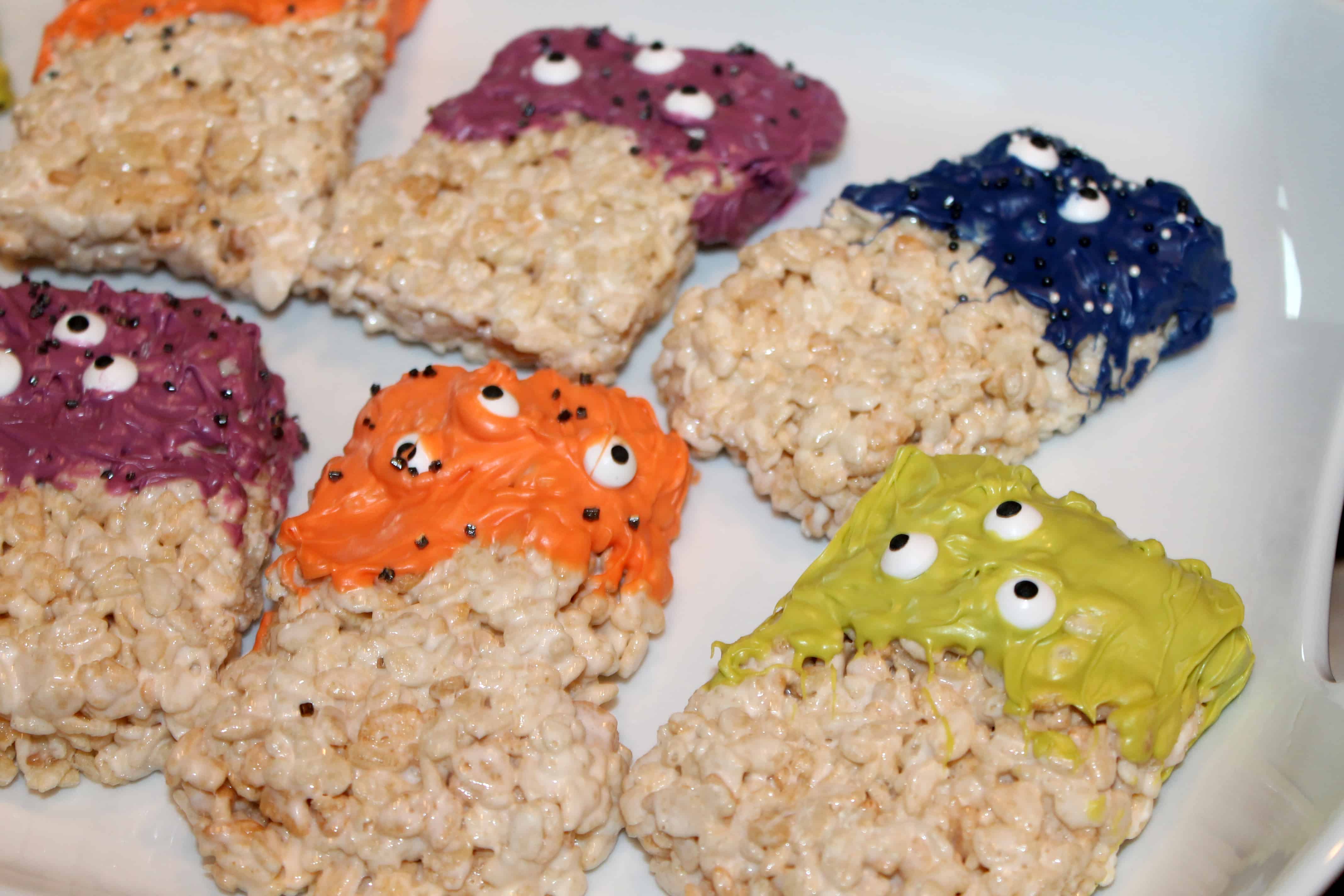 a bunch of fun rice krispie treat monsters on a white platter