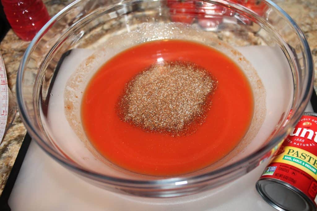 tomato paste, water and chili seasonings in a medium mixing bowl