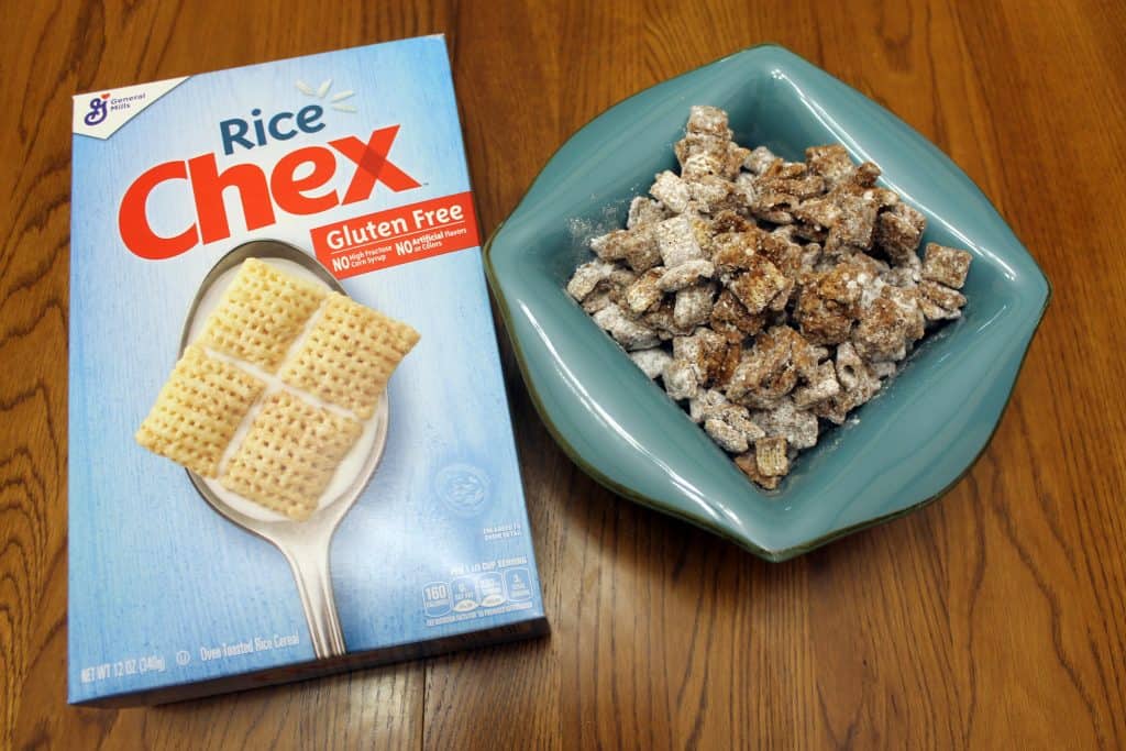 chex mix muddy buddies next to a box of rice chex cereal