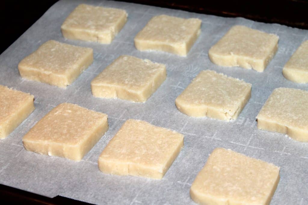 shortbread cookie dough slices placed on a cookie sheet