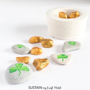 shamrocks and gold nuggets painted on rocks
