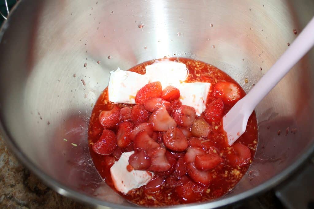 mixing bowl with cream cheese lemon zest and strawberry sauce